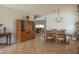 Open dining room features tile flooring, a large table, and a built-in cabinet at 11868 W Kinderman Dr, Avondale, AZ 85323