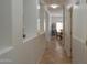 Hallway features tile floors and leads to dining room with decorative shelf at 11868 W Kinderman Dr, Avondale, AZ 85323