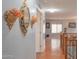 Upstairs hallway featuring hardwood floors, decorative wall hangings, and a staircase railing at 11868 W Kinderman Dr, Avondale, AZ 85323