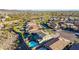 Neighborhood aerial view showcasing the home's pool, landscaping, and proximity to nearby roads and homes at 12918 W Caraveo Pl, Peoria, AZ 85383