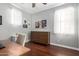 Comfortable bedroom featuring a wood dresser, hardwood floors and neutral decor at 12918 W Caraveo Pl, Peoria, AZ 85383