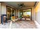 Covered patio with travertine floors, a ceiling fan, and sliding glass doors with mountain views at 12918 W Caraveo Pl, Peoria, AZ 85383