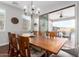 Elegant dining room with a large wooden table and chairs, opening to an outdoor patio at 12918 W Caraveo Pl, Peoria, AZ 85383