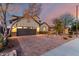 Exterior elevation of a home with desert landscaping, a two-car garage, and dusk sky at 12918 W Caraveo Pl, Peoria, AZ 85383