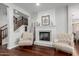 Cozy living room with a fireplace, hardwood floors, and traditional decor at 12918 W Caraveo Pl, Peoria, AZ 85383