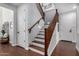 Bright staircase with wooden railing and white walls, providing access to upper floors at 12918 W Caraveo Pl, Peoria, AZ 85383