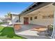 Covered back patio with an outdoor kitchen, ceiling fans, and stylish decor, ideal for outdoor dining and relaxation at 1414 E Vermont Ave, Phoenix, AZ 85014