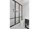 Modern bathroom with black framed glass shower and hexagonal tile at 1414 E Vermont Ave, Phoenix, AZ 85014