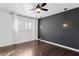 This bedroom features dark hardwood flooring, ceiling fan, stylish modern lighting, and bright light at 1414 E Vermont Ave, Phoenix, AZ 85014