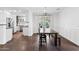 Bright dining area with dark wood floors, modern lighting, and access to outdoor space at 1414 E Vermont Ave, Phoenix, AZ 85014