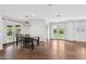 Well-lit dining room with hardwood floors, white walls, and doors leading to the backyard at 1414 E Vermont Ave, Phoenix, AZ 85014