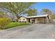 Charming single-story home with a covered carport, mature trees, a green lawn, and a spacious driveway at 1414 E Vermont Ave, Phoenix, AZ 85014