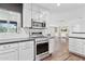 Modern kitchen featuring stainless steel appliances, white cabinets, and dark countertops at 1414 E Vermont Ave, Phoenix, AZ 85014