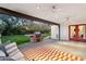 Inviting covered patio featuring an outdoor kitchen with brick grill and manicured lawn, perfect for entertaining at 1414 E Vermont Ave, Phoenix, AZ 85014