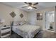 Cozy bedroom features soft lighting, ceiling fan, decor, and neutral color scheme at 145 N 74Th St # 121, Mesa, AZ 85207