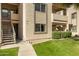 Apartment complex exterior featuring stairways, exterior storage, manicured landscaping, and neutral colors at 145 N 74Th St # 121, Mesa, AZ 85207