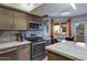 Contemporary kitchen featuring stainless steel appliances and an adjacent dining area with natural light at 145 N 74Th St # 121, Mesa, AZ 85207