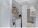 Convenient laundry area with modern washer and dryer, storage shelving, and access to bathroom at 145 N 74Th St # 121, Mesa, AZ 85207