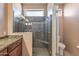 Bathroom showcases a glass shower with tile surround, bench, and modern fixtures at 15116 W Carbine Way, Sun City West, AZ 85375