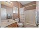 Cozy bathroom featuring classic white fixtures, including a vanity, toilet, and shower-tub combination at 15116 W Carbine Way, Sun City West, AZ 85375