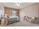 Serene bedroom features soft carpeting, a metal bed frame, and bright windows with plantation shutters at 15116 W Carbine Way, Sun City West, AZ 85375