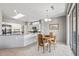 A dining area features tile flooring, a wood table set, and a skylight at 15116 W Carbine Way, Sun City West, AZ 85375