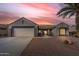 Charming single-story home with a tile roof, desert landscaping, and a welcoming two-car garage at 15116 W Carbine Way, Sun City West, AZ 85375