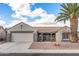 Charming single-story home featuring a tile roof, desert landscaping, and a two-car garage at 15116 W Carbine Way, Sun City West, AZ 85375