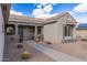 Charming home featuring a cozy covered porch with a tile roof and low-maintenance desert landscaping at 15116 W Carbine Way, Sun City West, AZ 85375