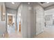 Inviting hallway with neutral walls and tile flooring leads to various rooms in this well-maintained home at 15116 W Carbine Way, Sun City West, AZ 85375