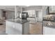 Bright kitchen with gray countertops, white cabinets, and modern black appliances at 15116 W Carbine Way, Sun City West, AZ 85375