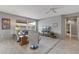 Spacious living room featuring plush seating, a large window, neutral tones, and a comfortable carpet at 15116 W Carbine Way, Sun City West, AZ 85375