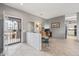 Inviting living area with tile flooring, a half wall partition, and plenty of natural light from the entry at 15116 W Carbine Way, Sun City West, AZ 85375