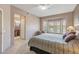 Spacious main bedroom featuring a bay window, and ensuite bathroom at 15116 W Carbine Way, Sun City West, AZ 85375