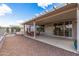 Enjoy outdoor living on this covered patio with ample seating and gravel landscaping at 15116 W Carbine Way, Sun City West, AZ 85375