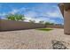 Backyard with rock landscaping and artificial turf at 1557 E Flower St, Gilbert, AZ 85298