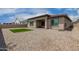 Backyard with rock landscaping and artificial turf at 1557 E Flower St, Gilbert, AZ 85298