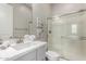 Bathroom featuring gray vanity, shower with glass doors, and decorative wall art at 1557 E Flower St, Gilbert, AZ 85298