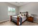 This quaint bedroom features neutral carpet, shutters on the window, and a rustic wood bedframe at 1557 E Flower St, Gilbert, AZ 85298