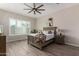 Beautiful bedroom with natural light, wood-look flooring, and a modern ceiling fan at 1557 E Flower St, Gilbert, AZ 85298