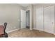 Neutral bedroom featuring carpet flooring, closet, and a view to the hallway at 1557 E Flower St, Gilbert, AZ 85298