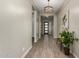 Elegant home foyer with wood-look tile floors and modern chandelier at 1557 E Flower St, Gilbert, AZ 85298