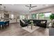 Relaxing living room featuring sleek, modern furniture, wood-look tile floors, and ample natural light at 1557 E Flower St, Gilbert, AZ 85298