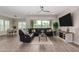 Relaxing living room featuring sleek, modern furniture, wood-look tile floors, and ample natural light at 1557 E Flower St, Gilbert, AZ 85298