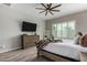 The main bedroom offers wood floors, ceiling fan, and plantation shutters for natural light at 1557 E Flower St, Gilbert, AZ 85298