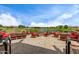 Outdoor seating with red chairs surrounding fire pit overlooking the pond at 1557 E Flower St, Gilbert, AZ 85298