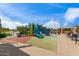 Community playground area with slide, climbing wall, and shaded benches at 1557 E Flower St, Gilbert, AZ 85298