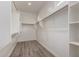 This walk-in closet provides ample storage space with wood floors and adjustable shelving at 1557 E Flower St, Gilbert, AZ 85298