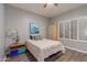 This bedroom features neutral decor, a ceiling fan, and lots of natural light at 15646 E Sunflower Dr, Fountain Hills, AZ 85268