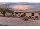 Charming single-story home featuring desert landscaping, barrel tile roof, and inviting curb appeal at sunset at 15646 E Sunflower Dr, Fountain Hills, AZ 85268